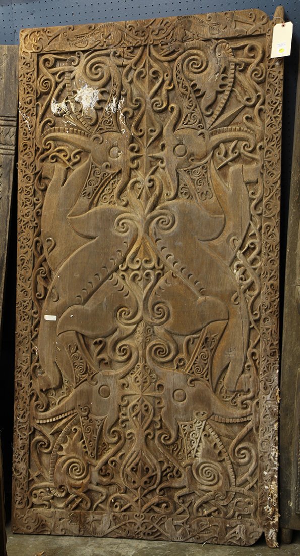 Southeast Asian carved door, the decorative plank: Southeast Asian carved door, the decorative plank featuring stylized birds surrounded by tribal patterns, 75"h x 39"w. Provenance: From the estate of Edward Gerber