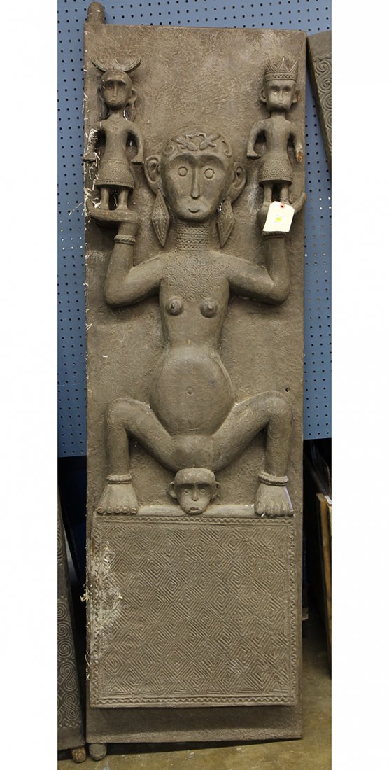 Southeast Asian carved door: Southeast Asian carved door, the heavily decorative plank featuring a female figure upholding in each hand a prince and princess, 81.5"' x 25"w. Provenance: From the estate of Edward Gerber