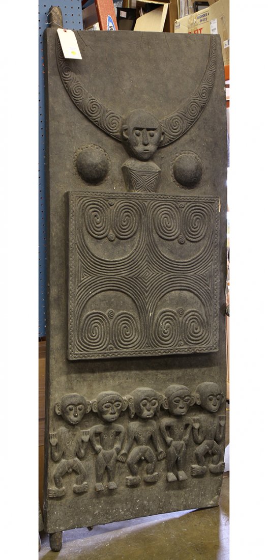 Southeast Asian carved wood door, the heavy decorative: Southeast Asian carved wood door, the heavy decorative plank with a relief carved figure centered with geometric accents, 81"h x 25"w. Provenance: From the estate of Edward Gerber