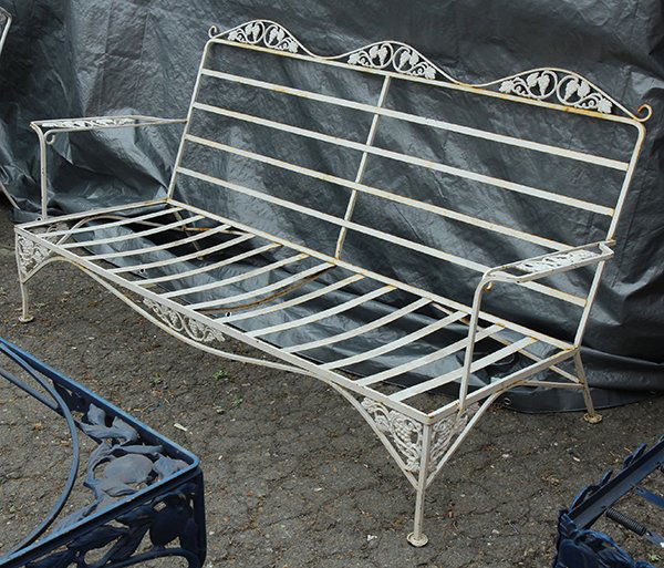 (lot of 7) Mid Century wrought iron patio furniture by: (lot of 7) Mid Century wrought iron patio furniture by Woodard, consisting of a 'Pomegranate' chaise lounge, occasional table, low table, and lounge chair, together with a settee and two armchairs hav