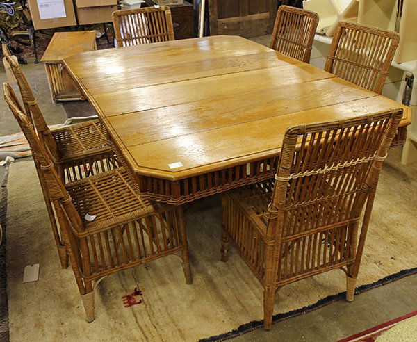 (lot of 7) Mcguire style rattan dining suite: (lot of 7) Mcguire style rattan dining suite, consisting of a dining table having two 11.5"w leaves and rising on an outswept base conjoined with an X-form stretcher, 29"h x 71.5"w x 48"d, and six sid