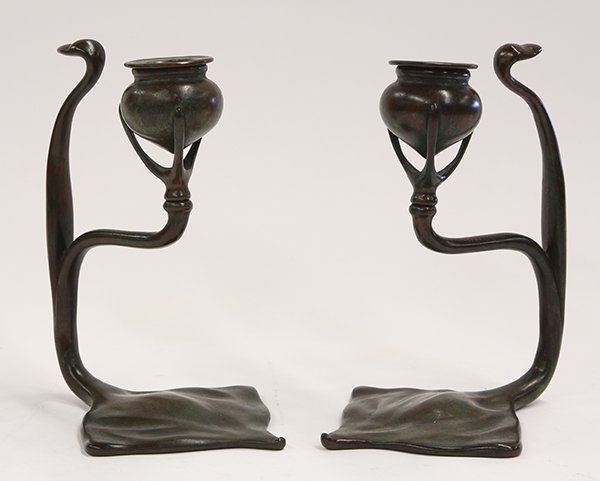 Pair of Tiffany Studios New York "Cobra" candlesticks: Pair of Tiffany Studios New York "Cobra" candlesticks, the patinated bronze form having a verdis patina with a stylized figural design depicting a snake, and rising on a shaped base marked Tiffany Stu