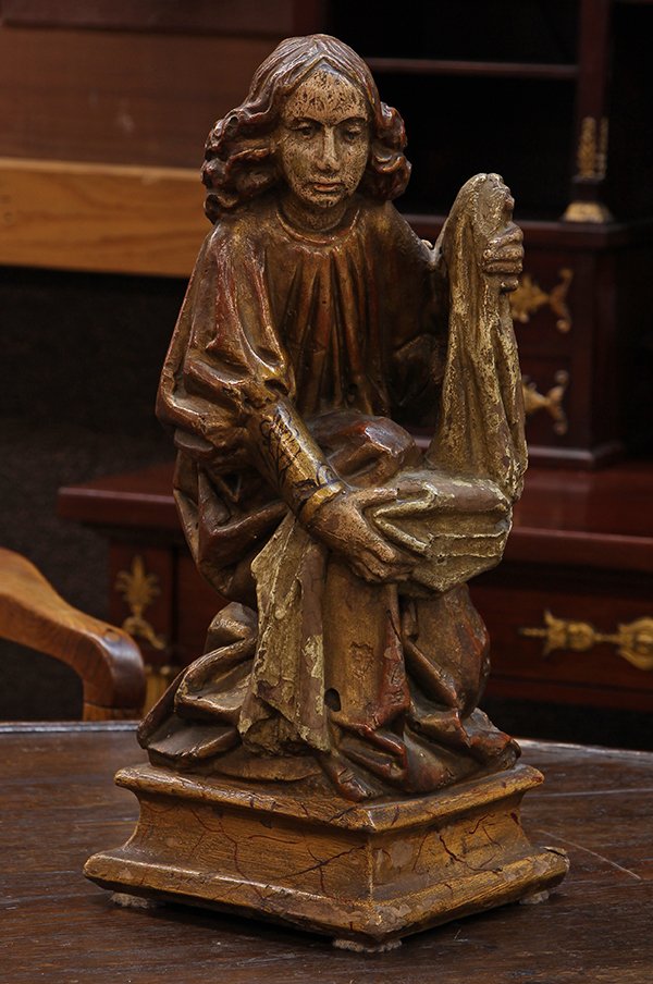 Continental Santos figure, possibly late 19th century,: Continental Santos figure, possibly late 19th century, executed in polychrome decorated plaster, depicting a kneeling figure grasping a shroud, 15"h