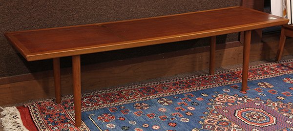 Danish Mid Century modern coffee table by Frem Rojle: Danish Mid Century modern coffee table by Frem Rojle, executed in teak, having a rectangular top, rising on tapered legs, stamped "Frem Rojle made in Denmark", 17.25"h x 63.5"w x 19.5"d