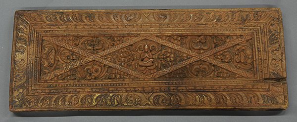 Two Himalayan Wood Sutra Covers: (lot of 2) Himalayan wooden manuscript covers, one of a bodhisattva amid tendrils and floral bands; the other with Eight Buddhist Treasures and grottoes now lacking figures, the edge carved with Tibet