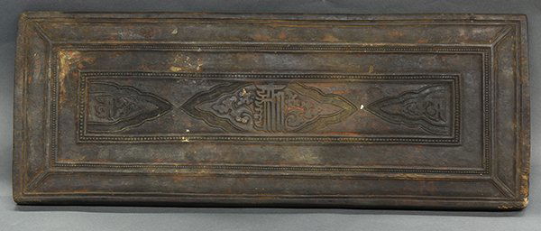 Three Himalayan/Tibetan Sutra Covers: (lot of 3) Himalayan wooden manuscript covers, the first carved with an amphora flanked by interlinked scrolling tendrils, within petal bands; second, with beaded bands and traces of red pigments; thi