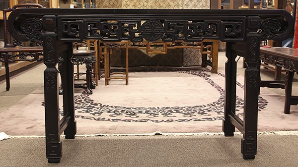 Chinese Wooden Altar Table: Chinese hardwood altar table, with a single floating top panel within a plain edge, the apron pierced with a shou medallion and scrolls, flanked by ruyi head spandrels, raised on carved legs, 33"h x 6