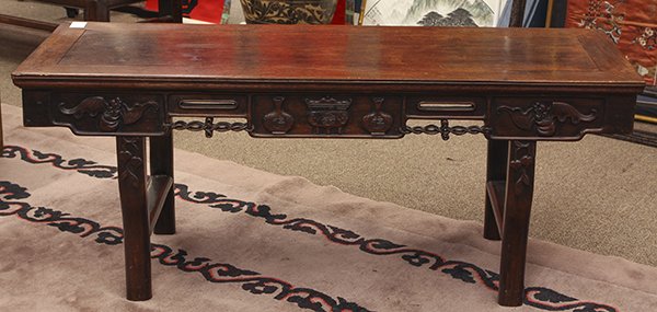 Chinese Low Table: Chinese altar table, now altered as a low table, with a single floating top panel, the apron carved with censer, vases and bats, raised on shaped supports, 20"h x 49"w x 17"d