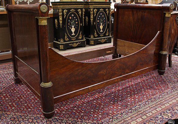 French Empire ormolu mounted lit d'alcove: French Empire ormolu mounted lit d'alcove, circa 1830, executed in mahogany, having a cylindrical crest rail, flanked with two columnar pilasters accented with bronze mounts, 42"h x 77"l x 40"d