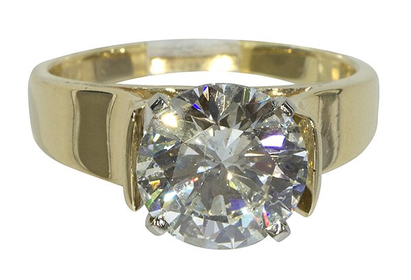Diamond and 14k yellow gold solitaire ring: Diamond and 14k yellow gold solitaire ring centering (1) round brilliant cut diamond weighing 5.09 cts., (actual weight) set in a 14k yellow gold high shoulder mounting, new 4-prong head, size 10 1/4,
