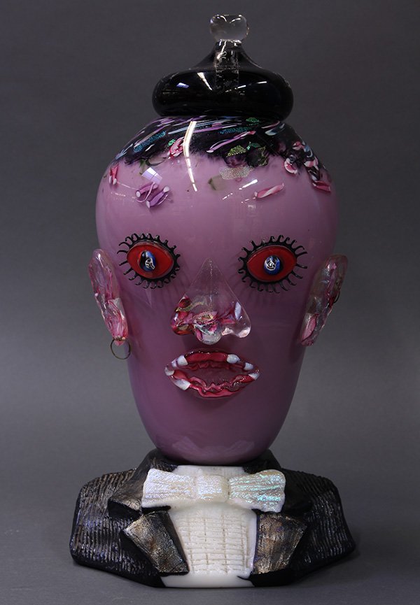 Signed and dated Murano style art glass figural covered: Signed and dated Murano style art glass figural covered potpouri jar, 1993, in the form of a bust of a man, executed in pink and black cased glass with iridescent inclusions, having applied metal eyel
