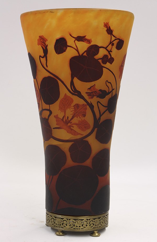 Daum Nancy France cameo glass vase: Daum Nancy France cameo glass vase, the three color form with floral sprays continuing to the circular base, marked Daum Nancy France, and rising on a reticulated brass footed base, 15"h x 7.5"w (crac