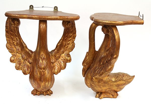(lot of 2) Continental style carved figural wall: (lot of 2) Continental style carved figural wall brackets, having tops with scalloped edges resting on swans with bent necks and spread wings, each with gilt finish, 15"h x 13"w x 9"d