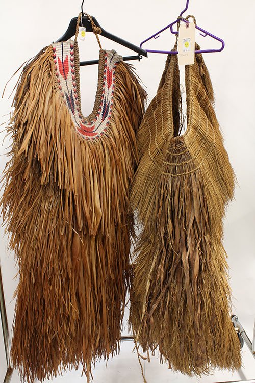 Two woven grass rain capes: Two woven grass rain capes