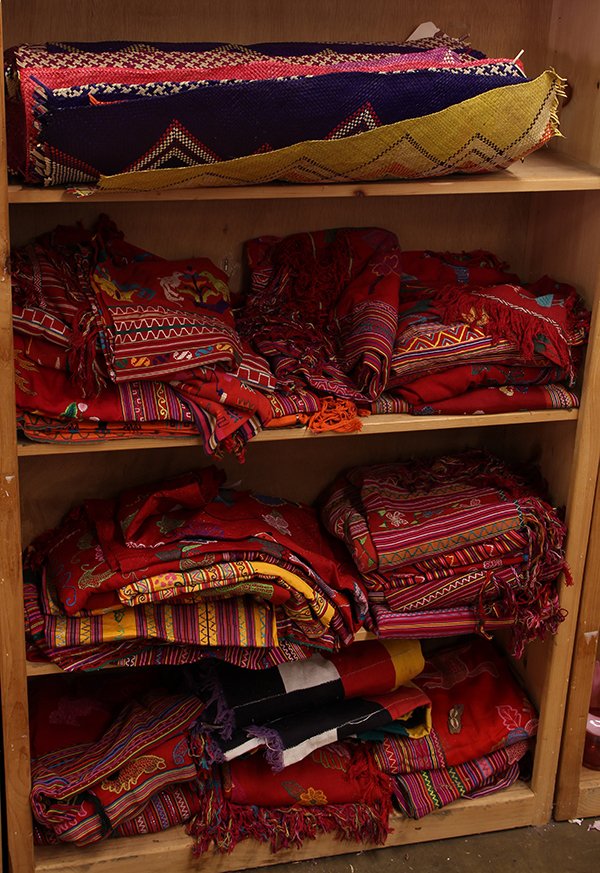 Indonesian hand woven textiles including hinggi men's: (lot of 50) Four shelves of Indonesian hand woven textiles including hinggi men's ceremonial wraps; together with a collection of East Asia and Philippine Islands Banig hand woven palm or sea grass ma