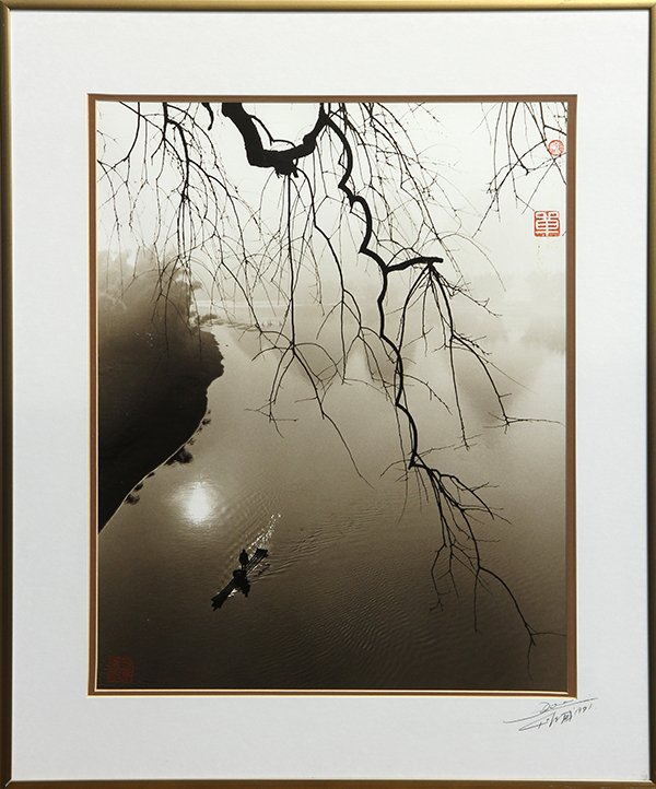 Photographs by Don Hong Oai: (lot of 2) Don Hong Oai (Chinese/American, 1919-2004), Vietnamese Worker Overlooking a Vast Landscape, and Down the River, 1991, each signed lower right, gelatin silver prints, Down the River with art