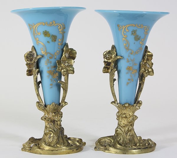 Pair of Rococo style gilt bronze and bristol glass: Pair of Rococo style gilt bronze and bristol glass epergnes, 19th century, each having a sky blue glass insert with scroll accents, and rising on a gilt bronze base decorated with floral sprays, 7"h.