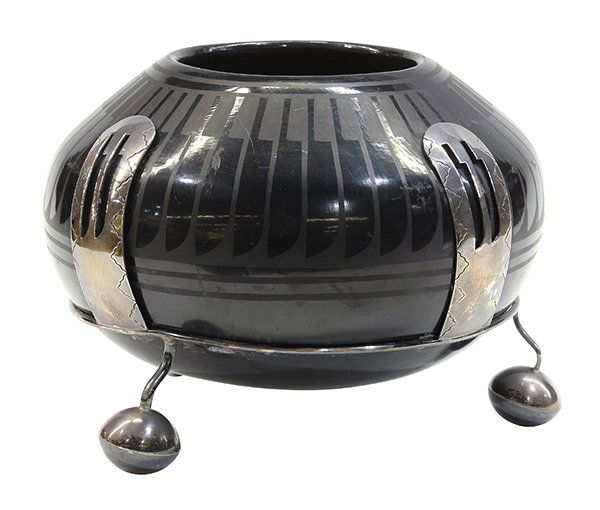 San Ildefonso blackware pottery bowl: San Ildefonso blackware pottery bowl, by Blue Corn, decorated with a repeating feather design and mounted in a silver plate fitted stand, signed verso "Blue Corn, San Ildefonso Pueblo", 8"h overall