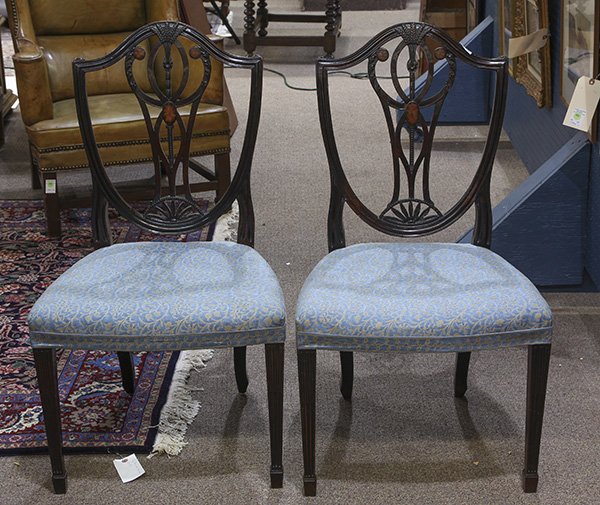 Pair of Hepplewhite carved mahogany and Fortuny: Pair of Hepplewhite carved mahogany side chairs, each having an inlaid shield back set with a pierced splat above the Fortuny upholstered seat, 36"h x 20.5"w x 18"d. Provenance: From the Pebble Beach,