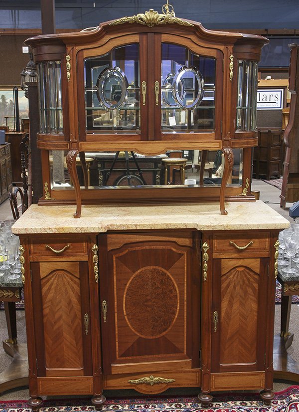 Continental carved and bronze mounted buffet: Continental carved and bronze mounted buffet, the marble top surmounted by a bevel glass superstructure raised on acanthus accented supports, the lower case executed with parquetry inlays, and centere