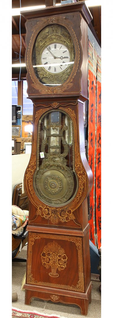French tall case Morbier clock circa 1880, marked Heude: French tall case Morbier clock circa 1880, marked Heude a Brionne, the relief decorated brass face with naturalistic sprays flanking the Roman numeral enamel dial, the lower case with a single window 