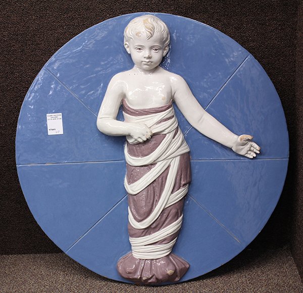 Della Robbia style polychrome decorated religious: Della Robbia style polychrome decorated religious plaque, decorated with the baby Jesus standing, his lower body wrapped in swaddling clothes, 12"h x 24"dia. Provenance: From the Pebble Beach, CA esta