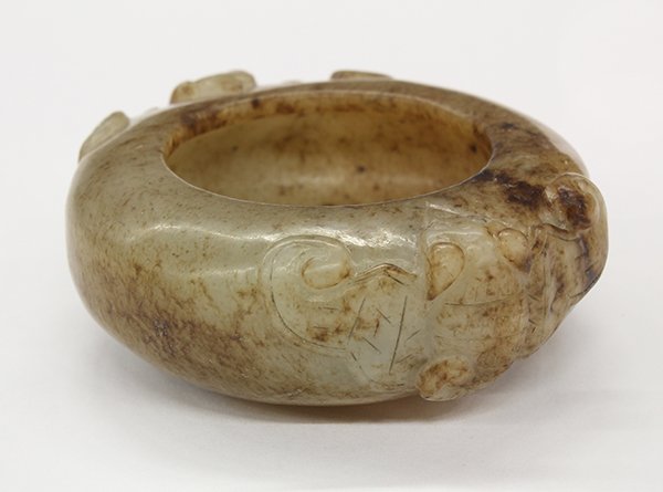 Chinese Small Jade Brush Washer: Chinese jade brush washer, having a compressed body carved with a pair of bat form handles, executed from a gray matrix with brown inclusions, with stand, jade: 2.25"w