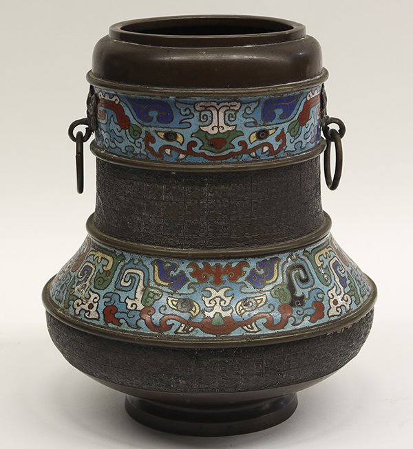 Japanese Champleve Enameled Vase: Japanese champleve enameled vase, with two enameled bands of taotie to the neck and shoulder, flanking the body cast with ruyi motifs, with two round handles to the neck, 12"h