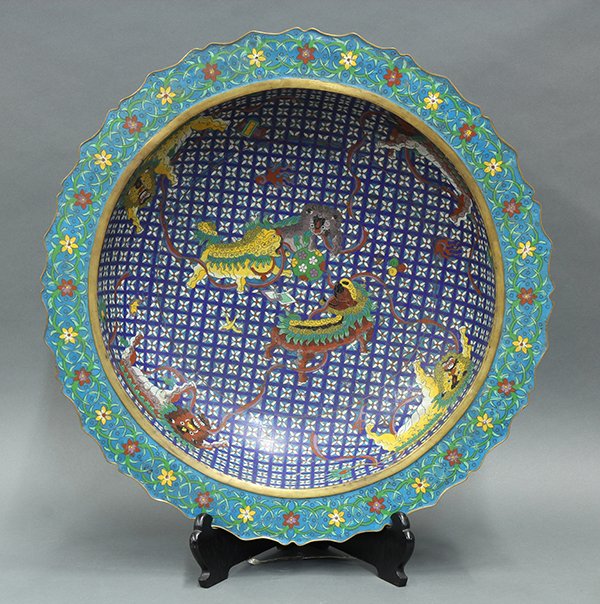 Chinese Cloisonne Basin: Chinese cloisonne enameled basin, the interior featuring seven fu-lions on a diaper ground, with an everted foliate rim, the exterior decorated with brocade balls, 21.5"w