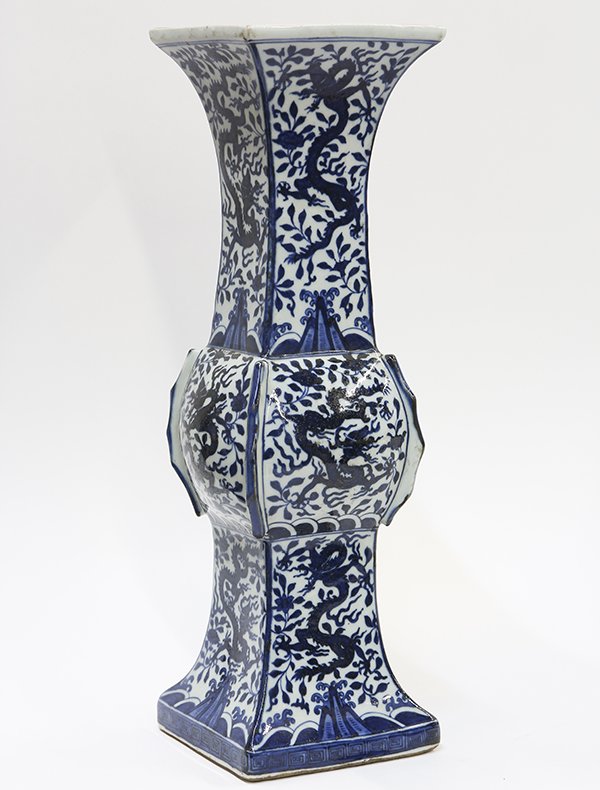 Chinese Blue and White Gu Form Vase, Dragon: Chinese underglaze blue porcelain gu form vase, with square sections decorated with dragons amid floral scrolls, the base with an apocryphal Jiajing mark, 17"h