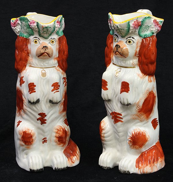 Pair of English Staffordshire pottery begging spaniel: Pair of English Staffordshire pottery begging spaniel pitchers, mid 19th century, depicting a pair of russet and white toy spaniels, each seated with their paws up, wearing gilt collars and lockets, a