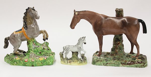 (lot of 3) English Staffordshire pearlware horses by: (lot of 3) English Staffordshire pearlware horses by Wood & Cauldwell, 19th century, consisting of a rearing horse figure rising on a naturalist base with bocage and applied flowers, with impressed ma