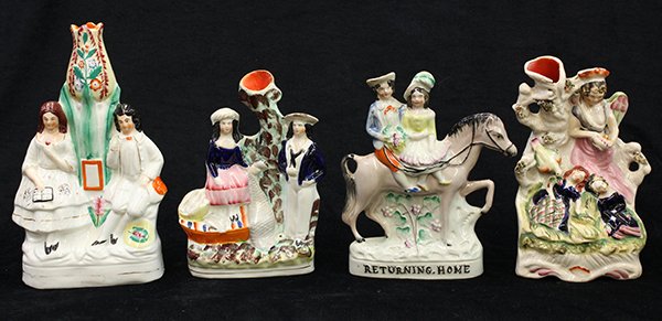 (lot of 4) English Staffordshire pearlware figural: (lot of 4) English Staffordshire pearlware figural groups, 19th century, consisting of a figure of an angel hovering over sleeping children dressed in cobalt with an exotic bird and a natural style tr