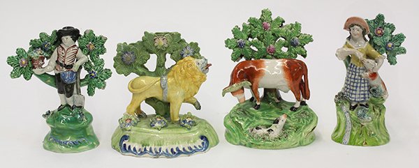 (lot of 4) English Staffordshire pearlware figural: (lot of 4) English Staffordshire pearlware figural groups, early 19th century, consisting of a man with a shovel and a basket resting against a bocage tree and rising on a circular base, 6"h x 4"w; a