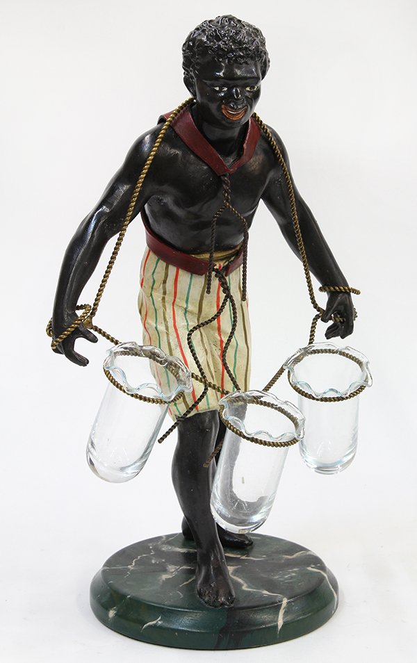 Continental Blackamoor figural epergne, executed in: Continental Blackamoor figural epergne, executed in patinated and enameled metal, the standing figure of a young man having a rope harness encircling three glass vessels, and rising on a faux marble b