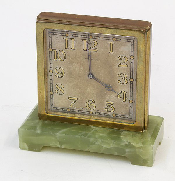 Hardy & Hayes Art Deco desk clock: Hardy & Hayes Art Deco desk clock, double sided with an eight day Swiss movement, having a square dial with Arabic numerals and a brass frame, the whole rising on a green stone base, 5"h. Provenance: