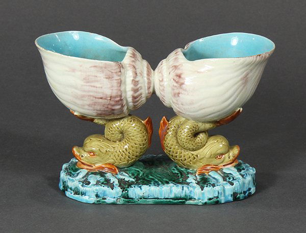 Royal Worcester majolica double shell and dolphin open: Royal Worcester majolica double shell and dolphin open salt, 19th century, modeled as conjoined moon shells glazed in puce on a cream ground with turquoise interior and rising on tan and orange dolphi