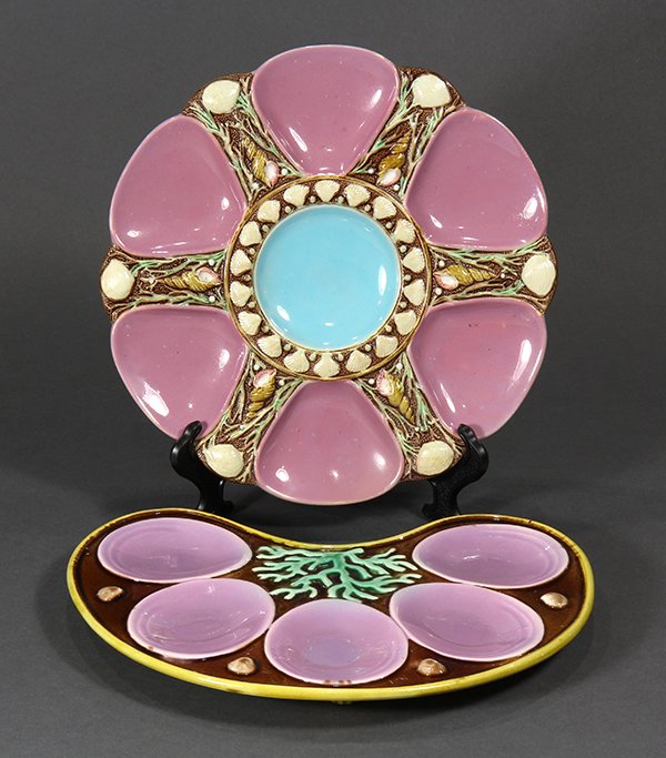 (lot of 2) Minton majolica pink ground oyster plates,: (lot of 2) Minton majolica pink ground oyster plates, 19th century, of scalloped form, the central circular well glazed in turquoise and molded with a band of shells, surrounded by six radiating wells