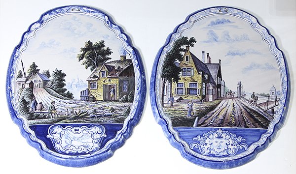 Pair of Continental faience plaques: Pair of Continental faience plaques, 19th/20th century, of oval form with a shaped rim, each having a hand-painted polychrome scene of a bucolic farm near a lake or river, marked with a blue 'F' verso