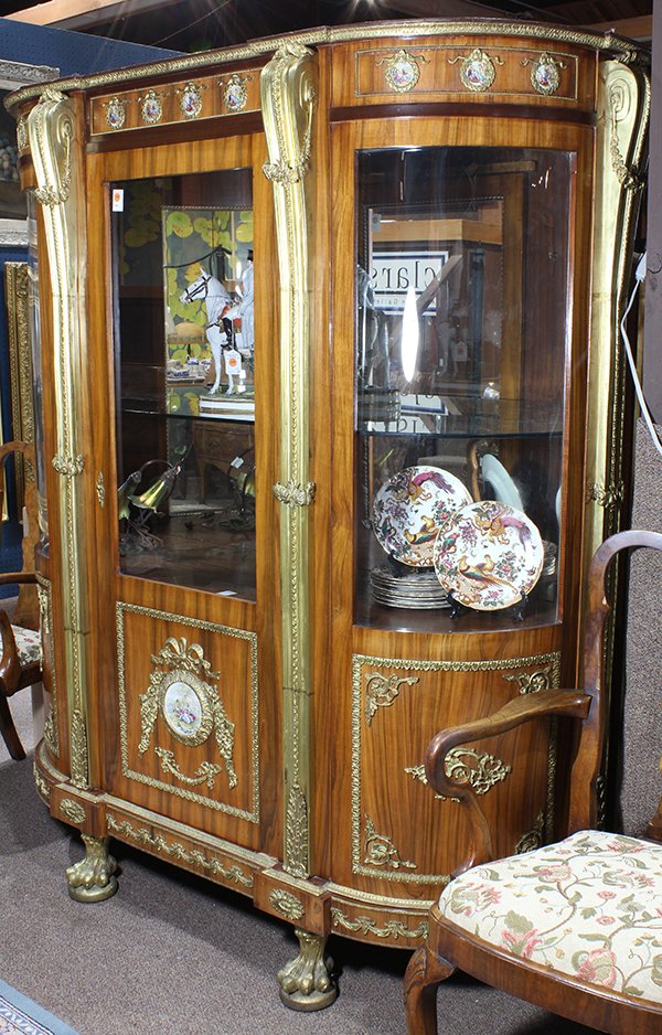 Louis XV style ormolu mounted lighted vitrine: Louis XV style ormolu mounted lighted vitrine, the shaped top having a gilt decorated border, above Sevres style porcelain inset plaques depicting Middle Eastern courting couples, continuing to the si