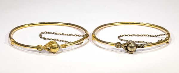 Pair of Victorian 14k yellow gold matching bangle: Pair of Victorian 14k yellow gold matching bangle bracelets the hinged bangles are designed with talons holding a sphere, both have safety chain, each having an inside diameter of approximately 2 3/8"