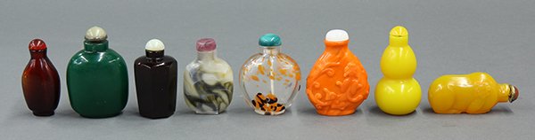 Eight Chinese Glass Snuff Bottles: (lot of 8) Chinese glass snuff bottles; consisting of two ruby colored bottles, one hexagonal and the other of tear drop form; the third of a yellow double gourd; the fourth of a pig; the fifth, a fla