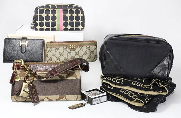 Designer fashion accessories: (lot of 8) Designer fashion accessories, consisting of two Gucci scarves; a Gucci canvas pouch; a Chanel black toiletry bag; a Kate Spade cosmetic pouch; a Chanel key chain on an associated sterling l