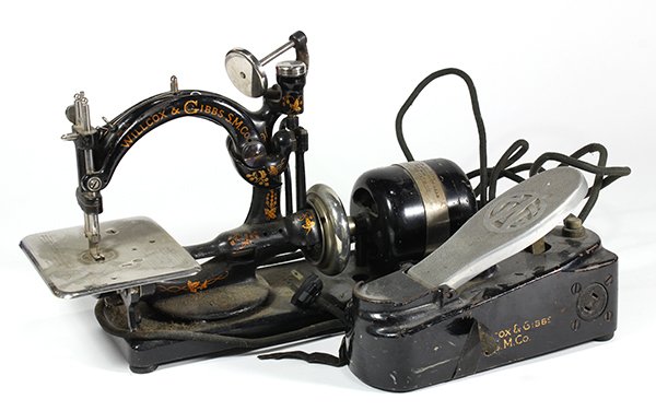 Willcox and Gibbs SM Co sewing machine: Willcox and Gibbs SM Co sewing machine, mid 19th century, executed in cast iron with gilt embellishment, this was one of the first chain stiching machines, with later motor and foot petal, 10"h x 16"l