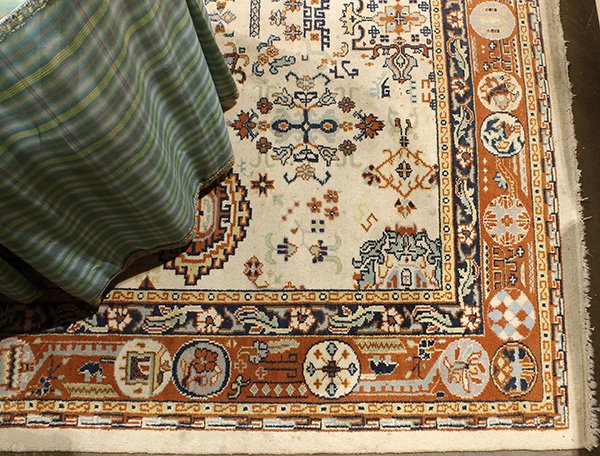 Nepalese style carpet: Nepalese style carpet, executed in brown and tan with blue accents on a cream field, 8'8' x 6'