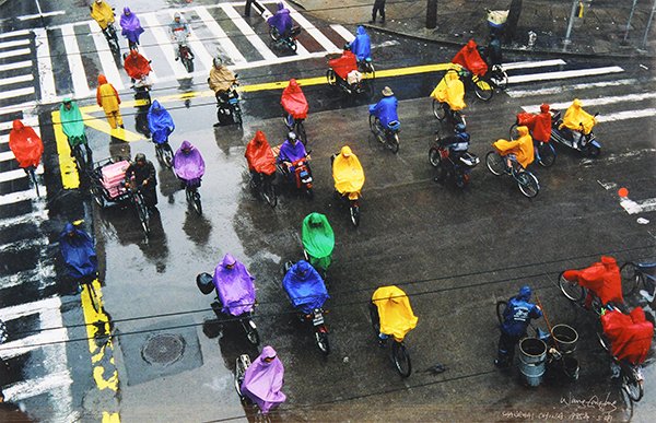 Photographs by Wang Gangfeng: (lot of 2) Wang Gangfeng (Chinese, b. 1956), Looking into the Lens (Anhui China), 1988, chromogenic print, signed lower left and dated, and Cyclists in the Rain (Shanghai China), 1995, signed lower ri