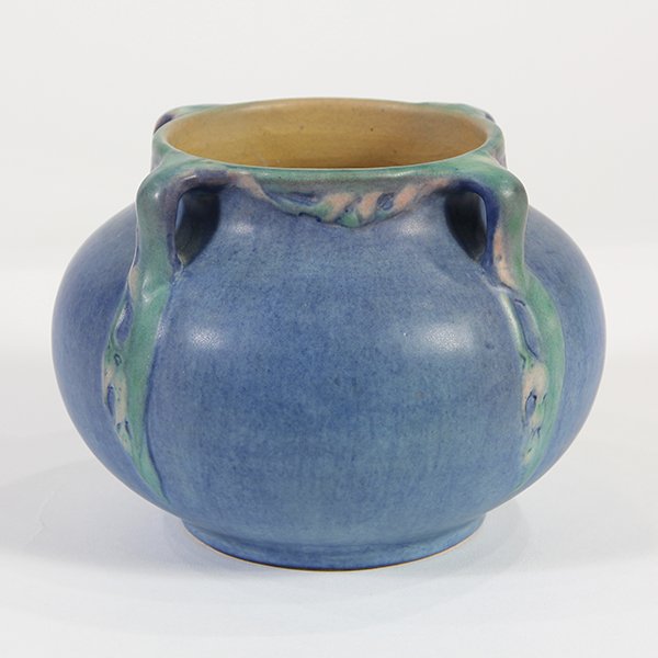 Newcomb College matte glaze art pottery four-handled: Newcomb College matte glaze art pottery four-handled vase, 1926, having a bulbous squat form, decorated by Sadie Irvine, having a matte glaze with blue and green underglaze, with nicotina leaves, unde