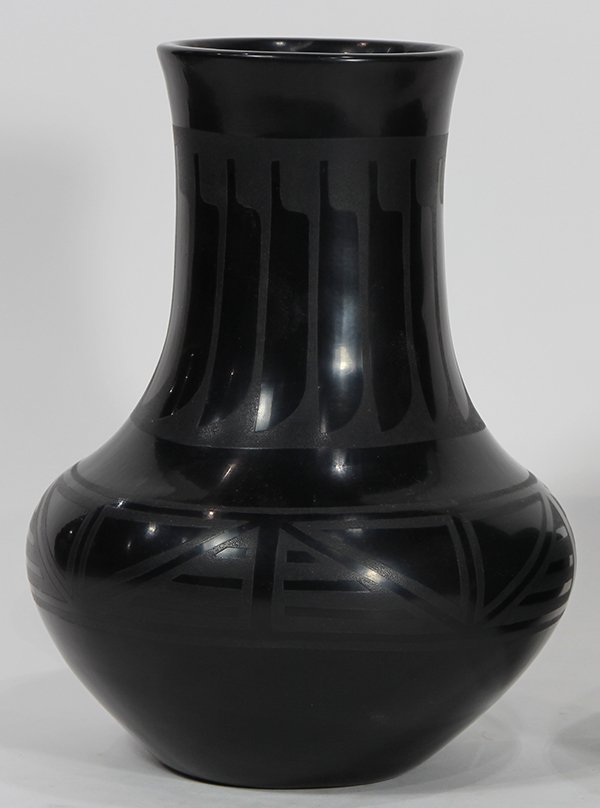 Marie and Santana San Ildefonso blackware pottery stick: Marie and Santana San Ildefonso blackware pottery stick neck vase, the neck decorated with repeating feather designs, above a geometric banding, pencil signed verso, 10"h