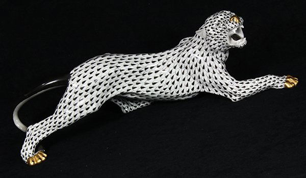 Hand painted porcelain tiger by Herend, decorated in: Hand painted porcelain tiger by Herend, decorated in the black Fish Net pattern with a black tail and gilt nose and paws, depicted in a crouching pose, model number 5209, marked Herend, 6"h x 18.5"w