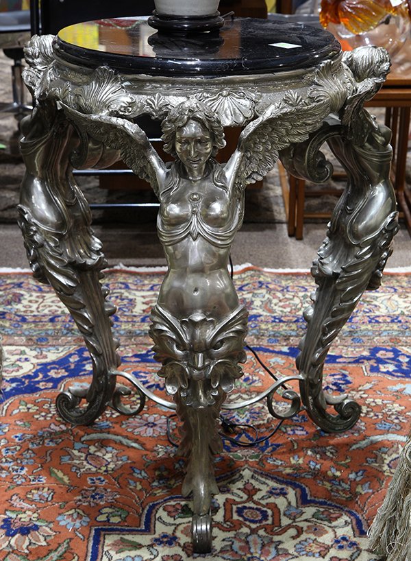 Pair of Renaissance style figural gueridons: Pair of Renaissance style figural gueridons, having a circular black marble top resting on a silvered base composed of three winged caryatids accented with Baroque style masks at the knees, and rising